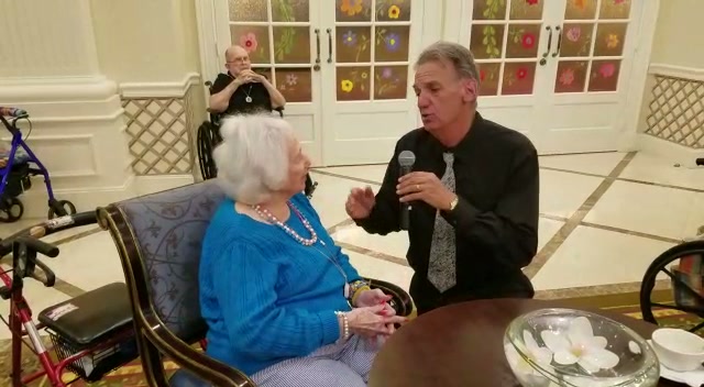Alan Cohen singing directly to a senior community resident